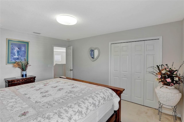 bedroom featuring light carpet and a closet