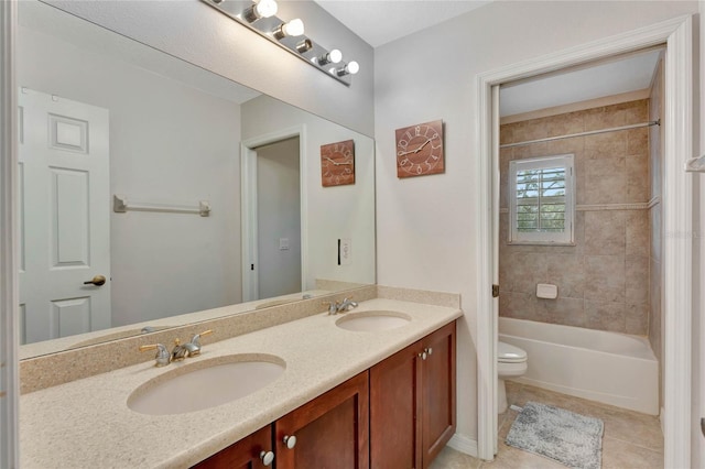 full bathroom featuring tile patterned floors, vanity, toilet, and tiled shower / bath combo