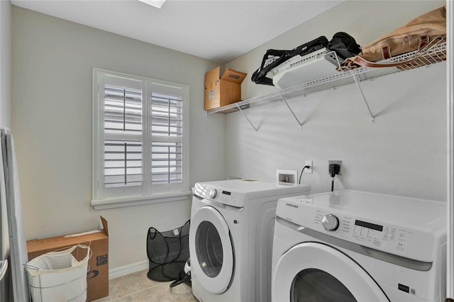 laundry area featuring washer and clothes dryer and light tile patterned floors