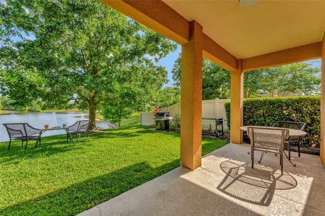 view of patio featuring a water view and area for grilling