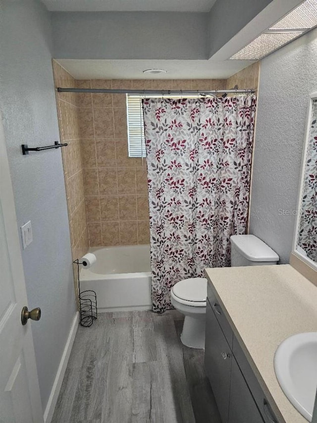 full bathroom with vanity, hardwood / wood-style floors, toilet, and shower / tub combo