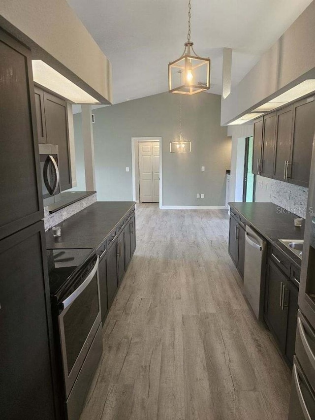 kitchen with light wood-type flooring, pendant lighting, dark brown cabinets, a notable chandelier, and stainless steel appliances