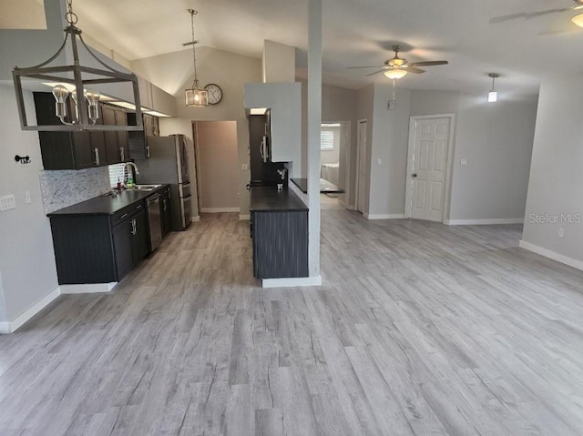 kitchen with ceiling fan with notable chandelier, light hardwood / wood-style flooring, lofted ceiling, and decorative light fixtures