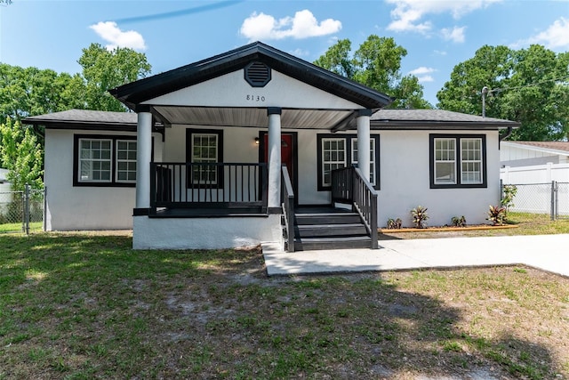 bungalow featuring a front lawn and covered porch