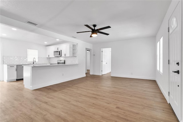 unfurnished living room with recessed lighting, visible vents, baseboards, a ceiling fan, and light wood finished floors