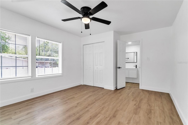 unfurnished bedroom featuring light wood-type flooring, a closet, and ceiling fan