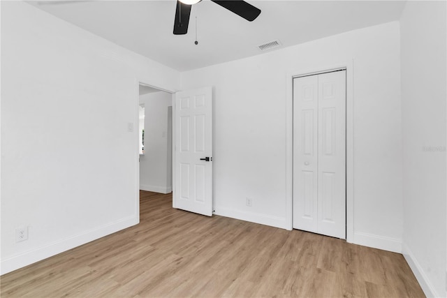 unfurnished bedroom with visible vents, baseboards, light wood-style flooring, ceiling fan, and a closet