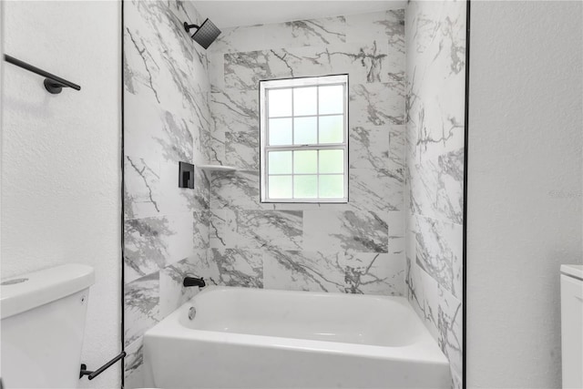 bathroom featuring washtub / shower combination, a textured wall, and toilet