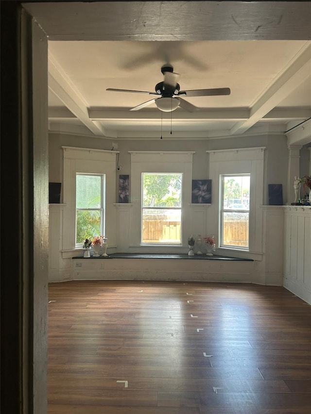 unfurnished living room featuring ceiling fan, plenty of natural light, and dark hardwood / wood-style flooring