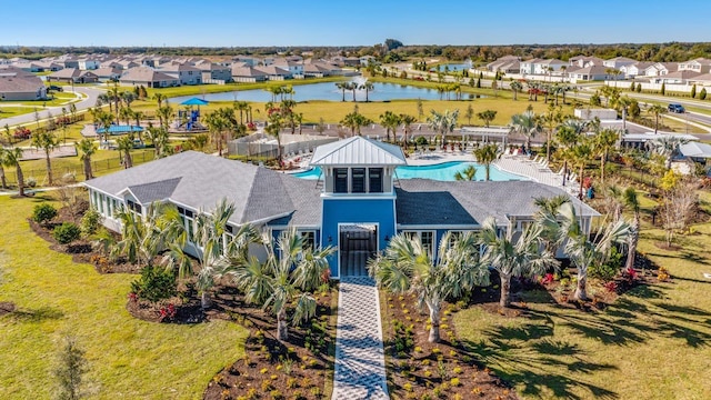 drone / aerial view featuring a residential view and a water view