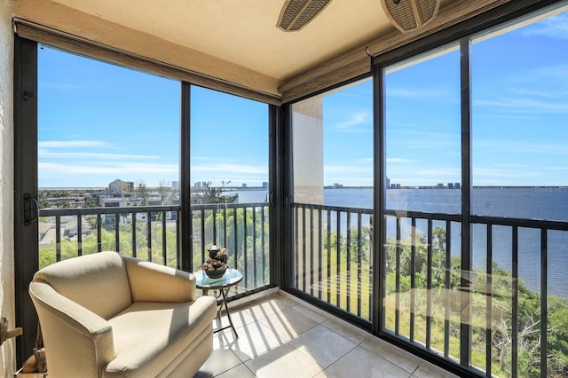 sunroom / solarium with a water view