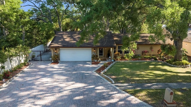 view of front of home featuring a garage and a front lawn