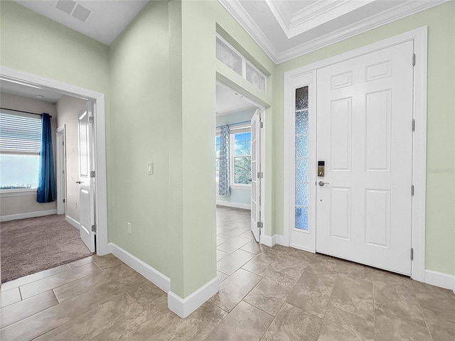 entryway featuring baseboards, visible vents, and crown molding