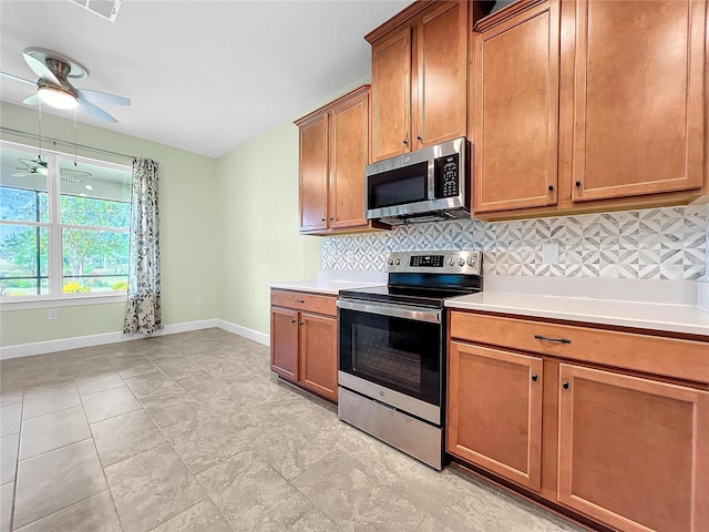 kitchen featuring tasteful backsplash, ceiling fan, stainless steel appliances, and light tile patterned floors