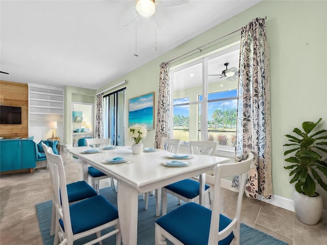 dining area with ceiling fan and light tile patterned flooring