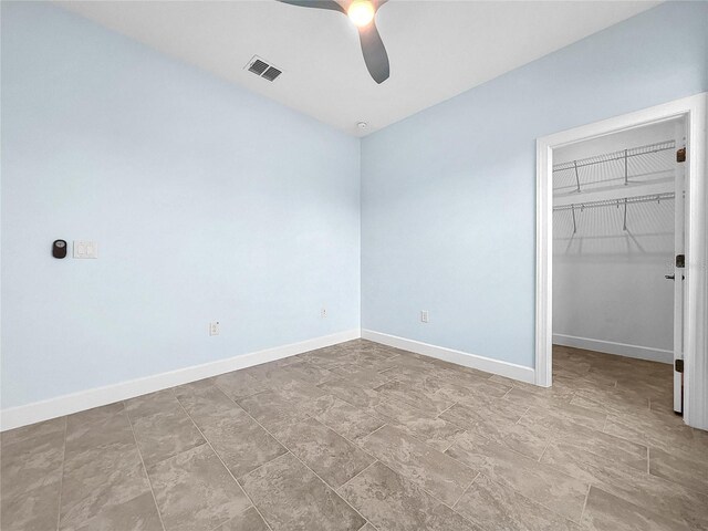 unfurnished bedroom with ceiling fan, tile patterned floors, and a closet