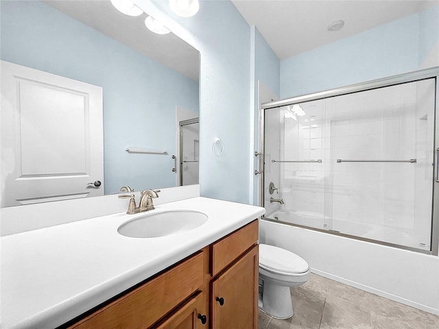 full bathroom with shower / bath combination with glass door, vanity, tile patterned flooring, and toilet