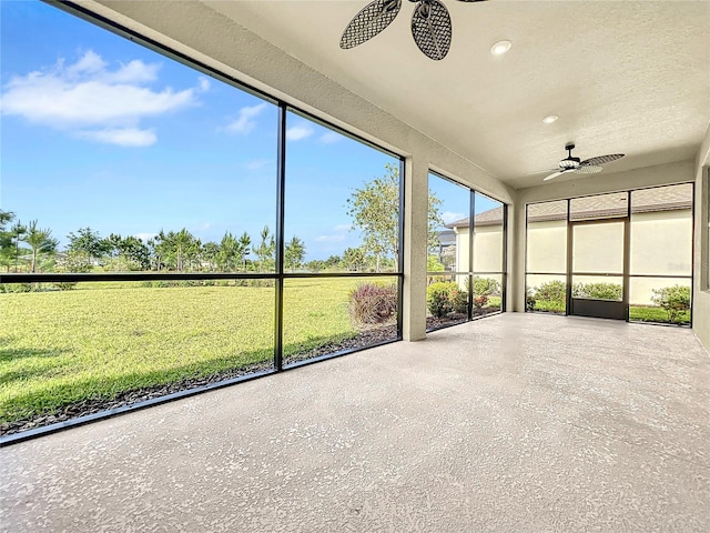 unfurnished sunroom featuring ceiling fan