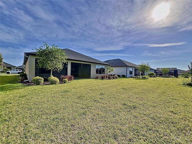 exterior space with a front lawn and stucco siding