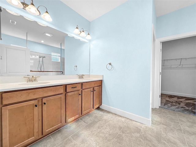 bathroom with a spacious closet, visible vents, walk in shower, and a sink