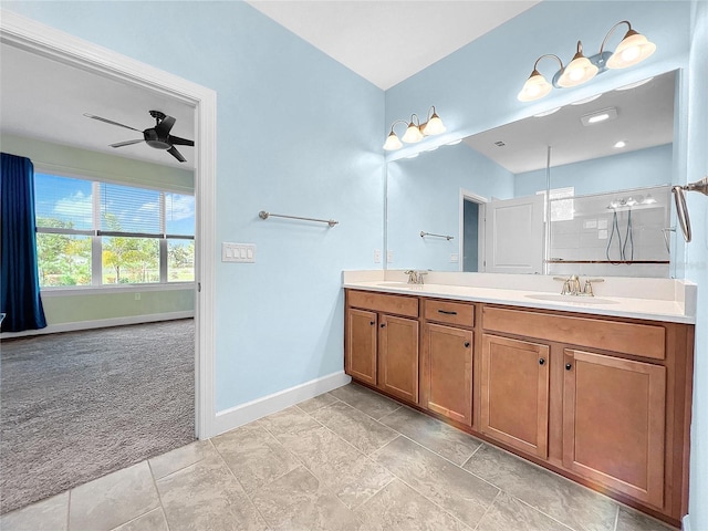 full bath featuring double vanity, baseboards, walk in shower, and a sink