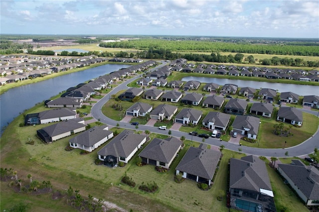 birds eye view of property featuring a water view and a residential view