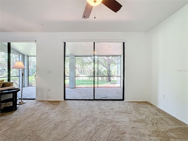 empty room with carpet flooring and ceiling fan