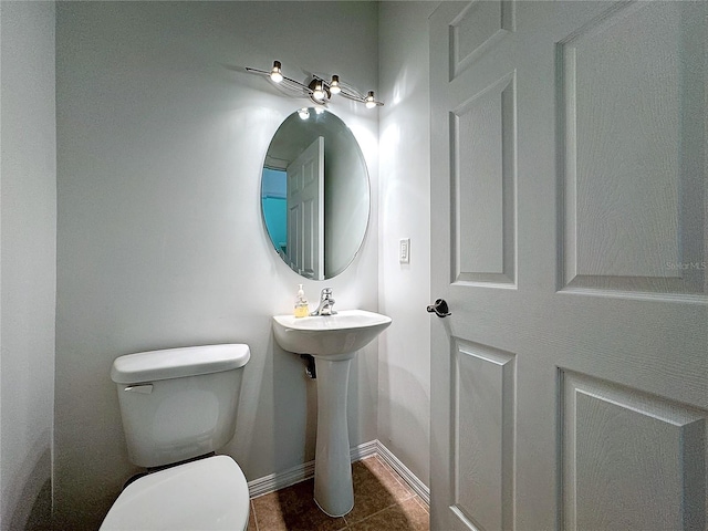 bathroom featuring tile patterned flooring and toilet