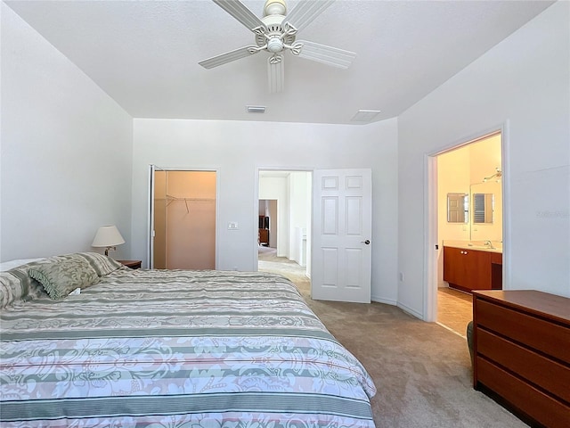 carpeted bedroom featuring ceiling fan, a walk in closet, connected bathroom, and a closet