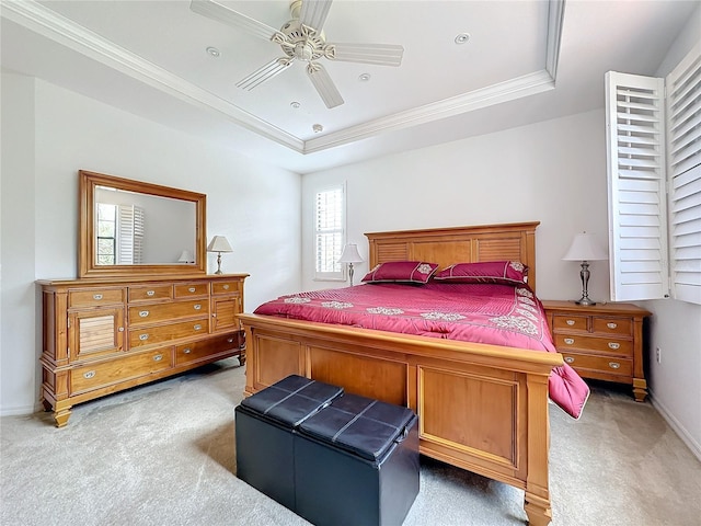 bedroom featuring carpet flooring, a raised ceiling, ceiling fan, and crown molding