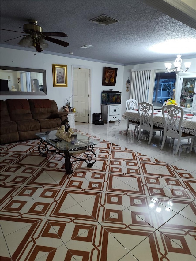 living room with ceiling fan with notable chandelier and a textured ceiling