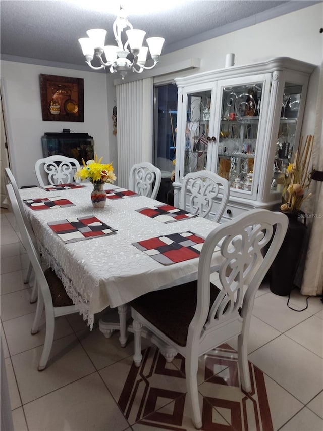 dining room with light tile patterned floors, a textured ceiling, and a notable chandelier