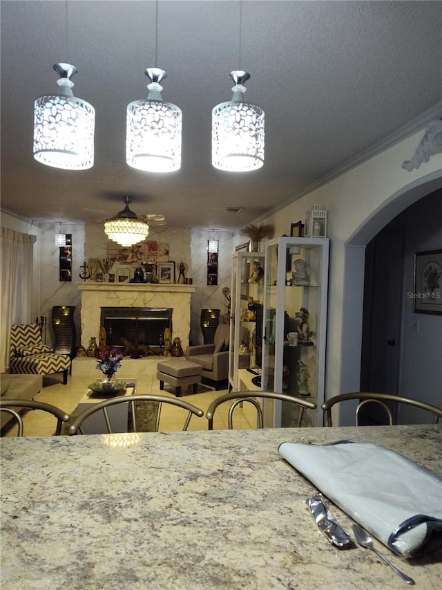 dining room featuring crown molding and a fireplace