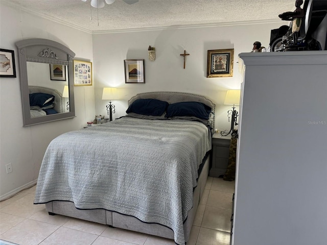 tiled bedroom featuring ceiling fan, a textured ceiling, and ornamental molding