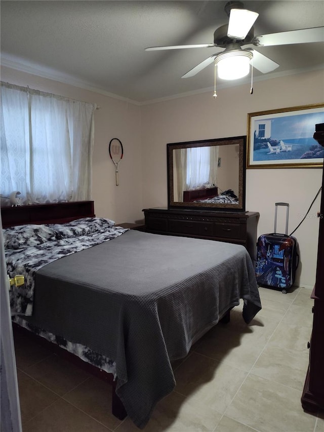 bedroom featuring light tile patterned floors, ceiling fan, and crown molding