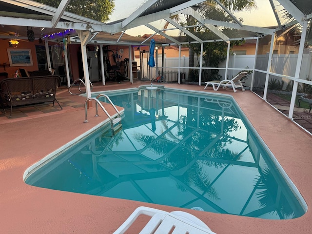 view of swimming pool with glass enclosure and a patio area