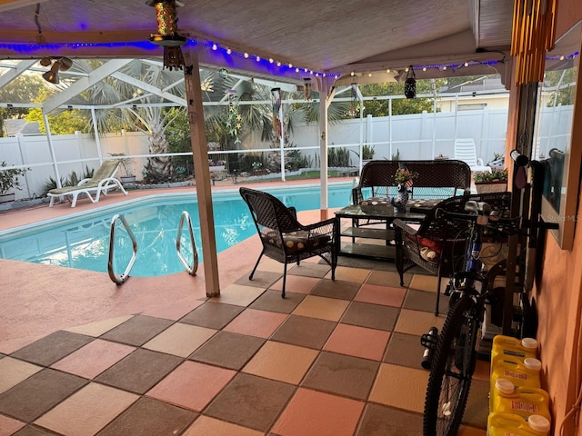 view of swimming pool featuring glass enclosure and a patio area