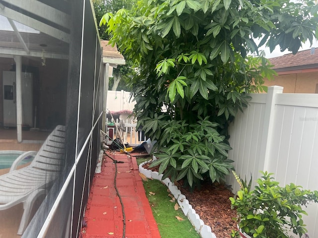 view of side of property with a lanai