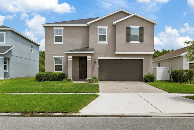 front facade featuring a garage and a front lawn