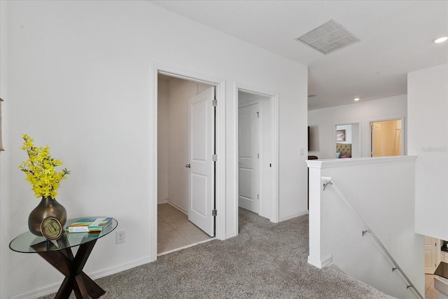 hall featuring light colored carpet