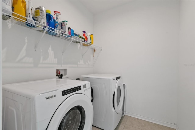 laundry area featuring hookup for a washing machine, independent washer and dryer, and light tile flooring