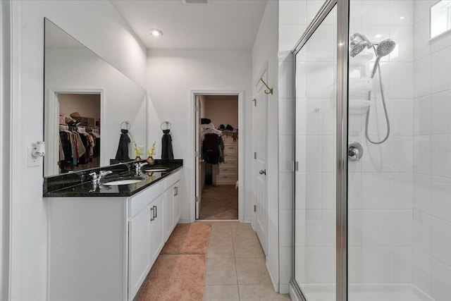 bathroom with a shower with door, tile flooring, and large vanity