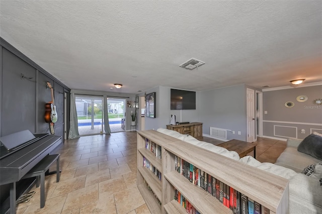 living room with tile patterned flooring and a textured ceiling