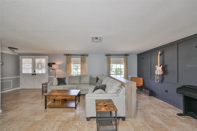 tiled living room with a textured ceiling