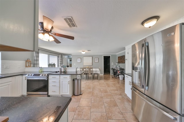 kitchen featuring white cabinets, stainless steel appliances, light tile patterned flooring, and ceiling fan