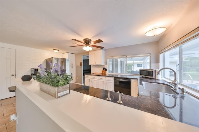 kitchen featuring white cabinetry, light tile patterned floors, ceiling fan, appliances with stainless steel finishes, and sink