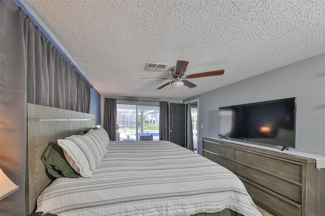 bedroom featuring a textured ceiling, ceiling fan, and access to exterior