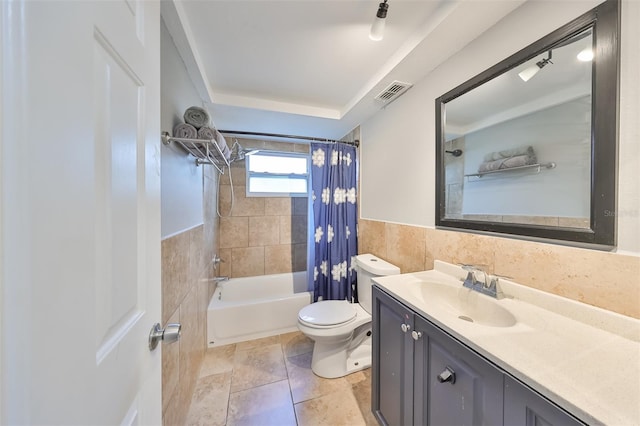 full bathroom featuring vanity, toilet, shower / tub combo, and tile walls