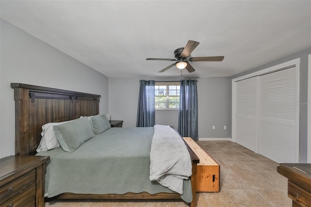 tiled bedroom with ceiling fan and a closet