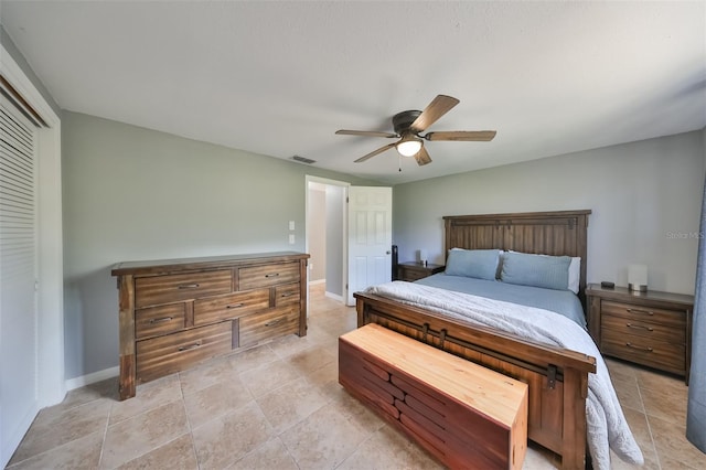 tiled bedroom featuring ceiling fan